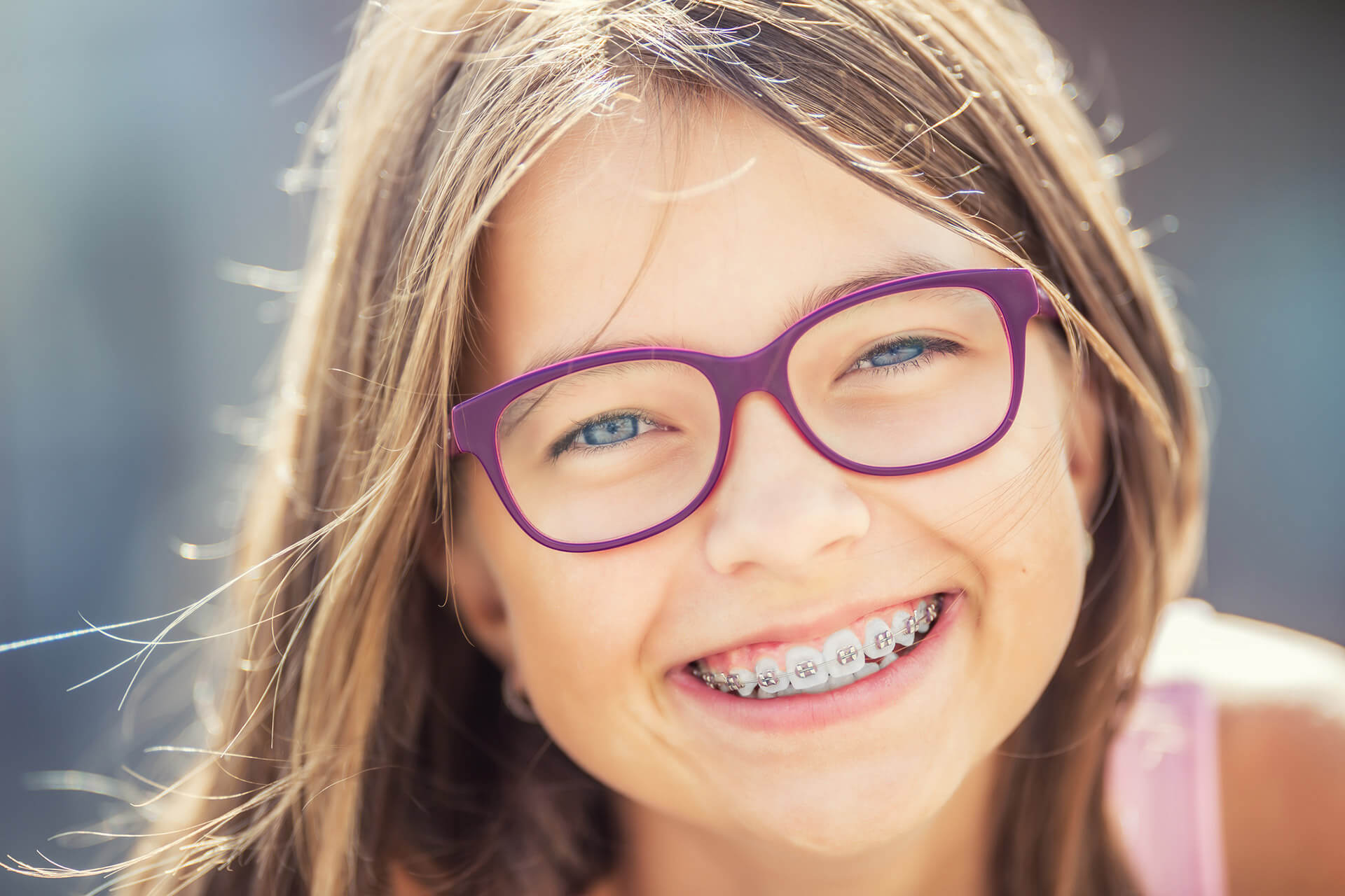 young girl with braces and glasses